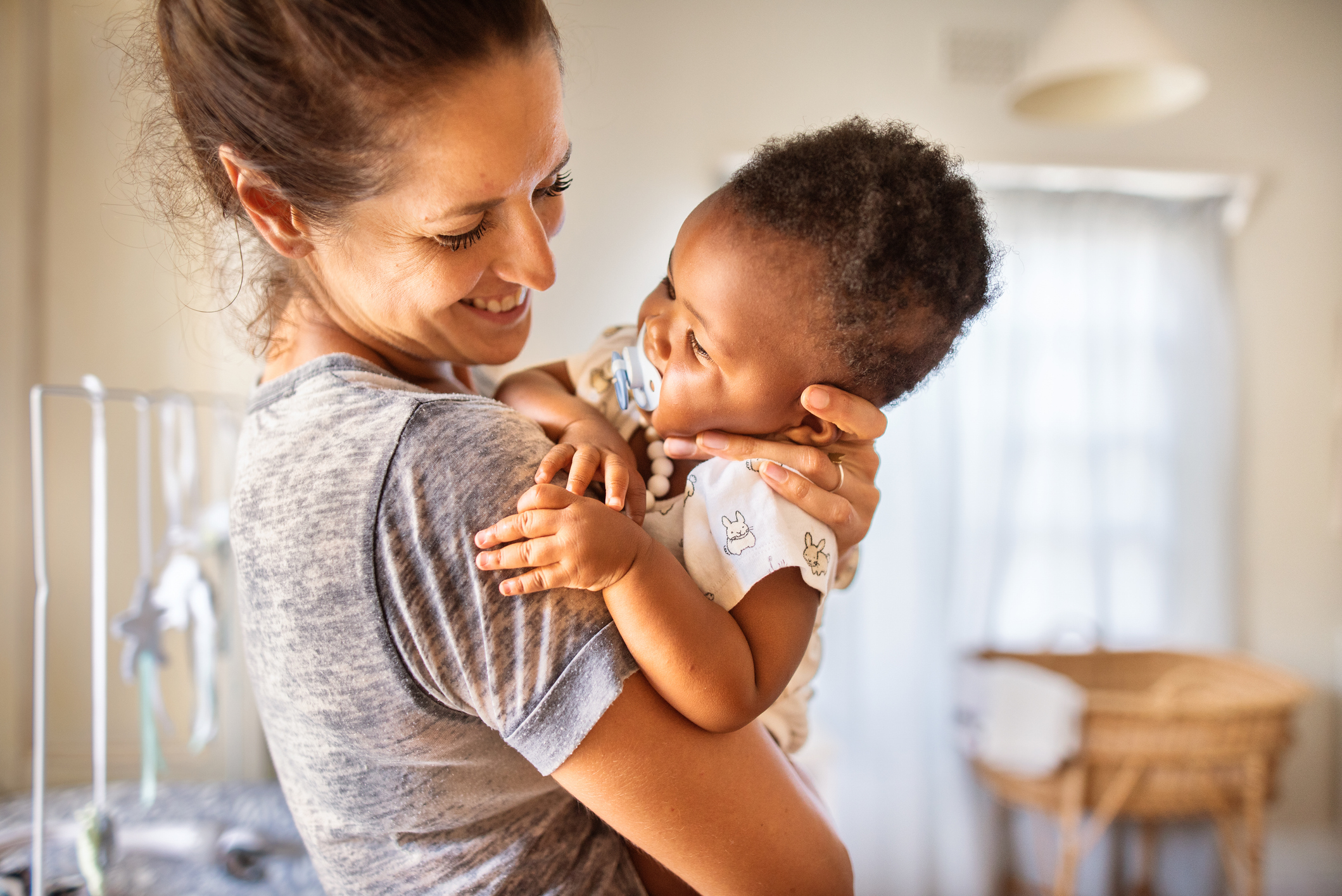 Smiling mother holding adopted baby girl