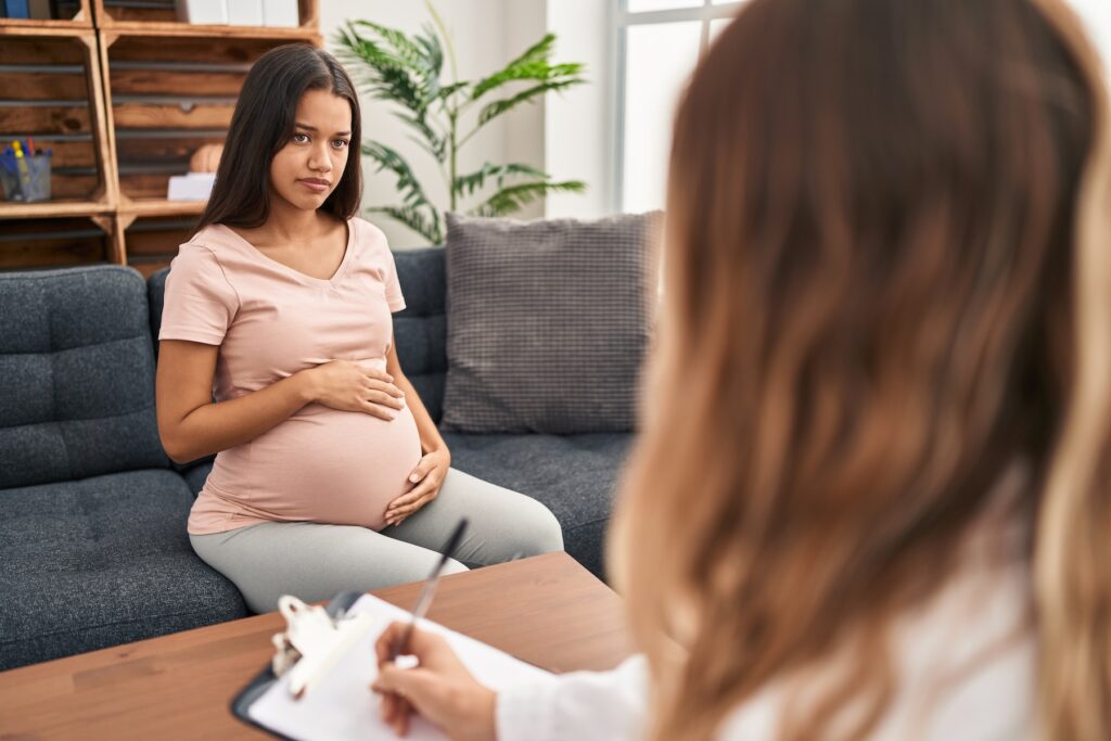 Young pregnant woman at counseling session